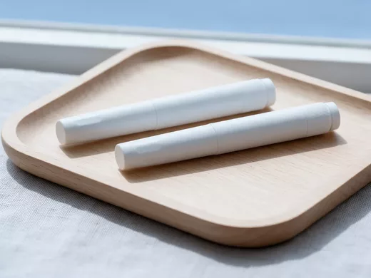 Deux stylos injecteurs sans marque posés sur un plateau en bois clair